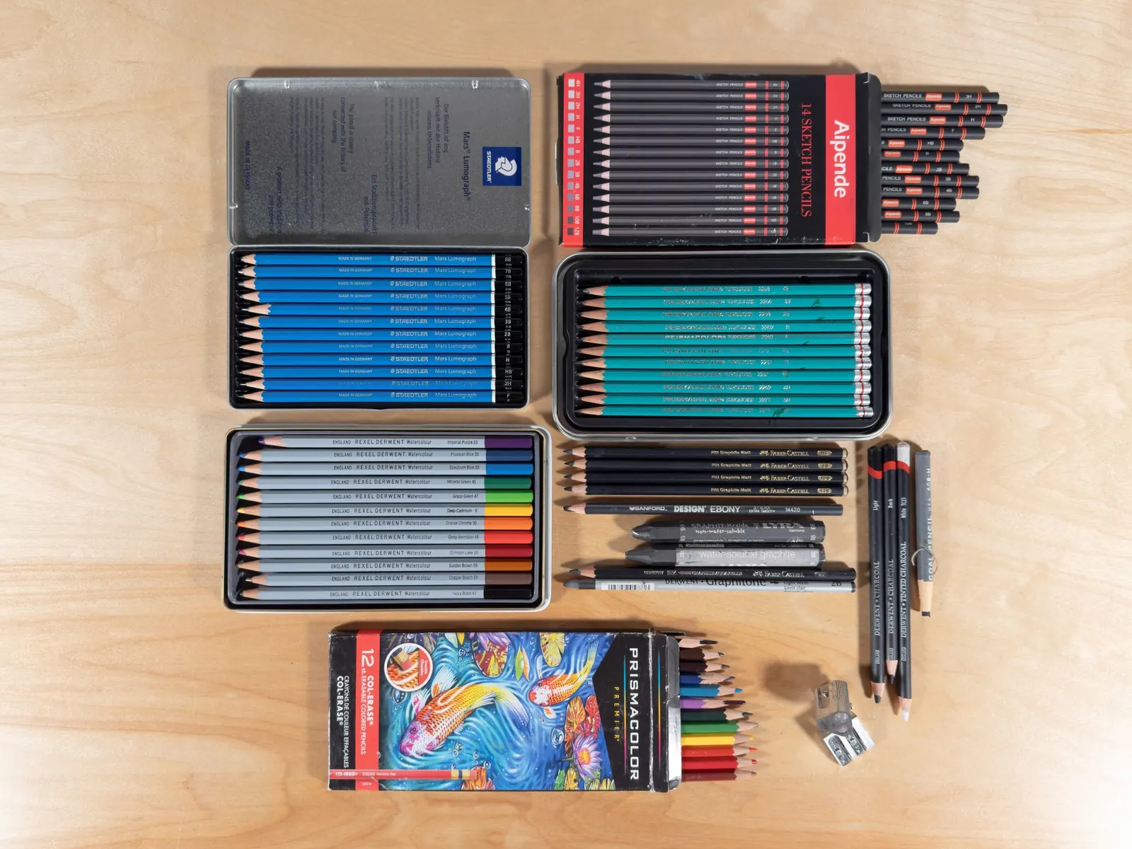 Drawing pencils and art supplies laid out on a table